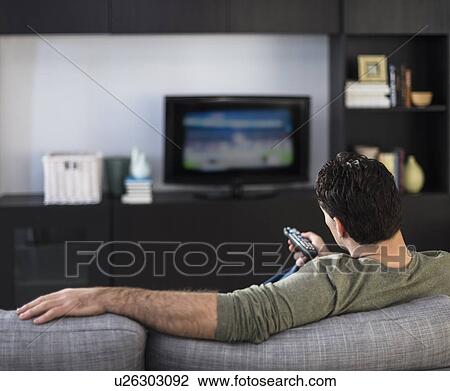 Rear view of man watching tv View Large Photo Image Stock Image - Rear view of man watching tv. Fotosearch