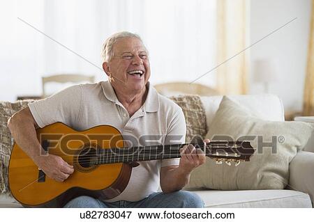 Stock Photo - Senior man playing guitar. Fotosearch