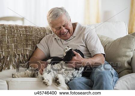 Senior man playing with dog View Large Photo Image Stock Image - Senior man playing with dog. Fotosearch