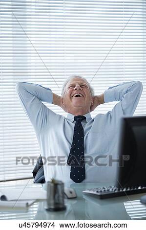 Senior man relaxing in office View Large Photo Image Picture - Senior man relaxing in office. Fotosearch