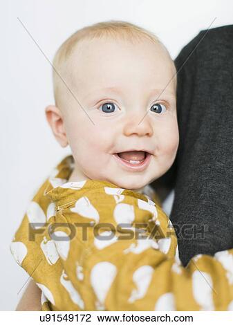 Stock Image - Studio portrait of baby boy (2-5 months). Fotosearch