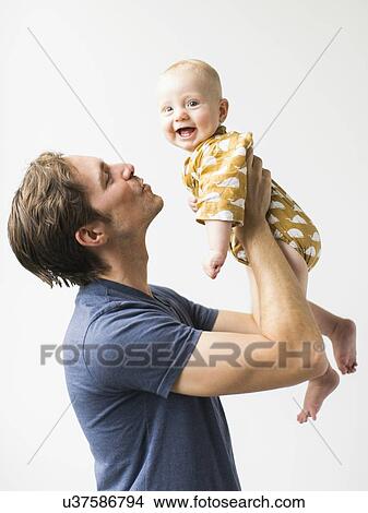 Studio portrait of father with baby son (2-5 months) View Large Photo Image Picture - Studio portrait of father with baby son (2-5 months). Fotosearch