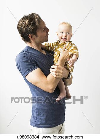Studio portrait of father with baby son (2-5 months) View Large Photo Image Picture - Studio portrait of father with baby son (2-5 months). Fotosearch