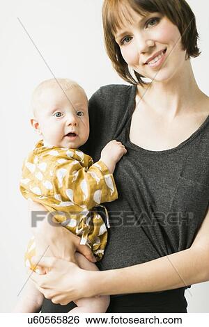 Studio portrait of mother with baby son (2-5 months) View Large Photo Image Stock Photograph - Studio portrait of mother with baby son (2-5 months). Fotosearch