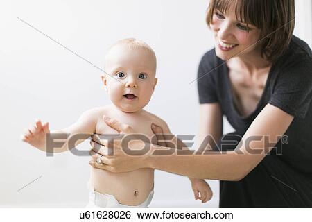 Studio portrait of mother with baby son (2-5 months) View Large Photo Image Stock Photograph - Studio portrait of mother with baby son (2-5 months). Fotosearch