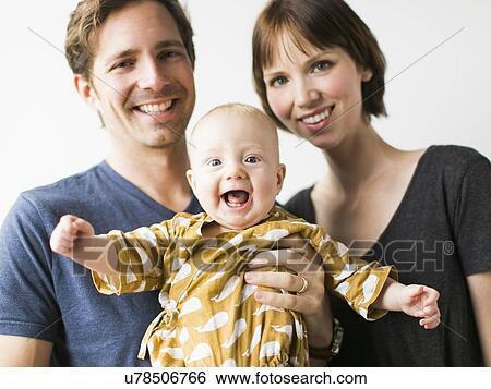 Studio portrait of parents with baby son (2-5 months) View Large Photo Image Stock Photograph - Studio portrait of parents with baby son (2-5 months). Fotosearch