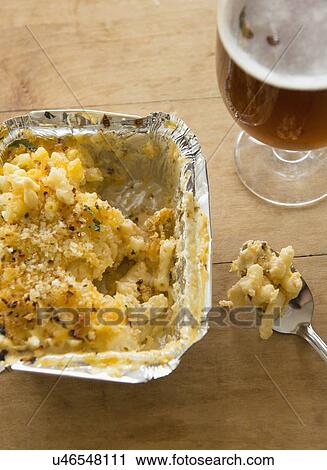 Stock Image - Studio shot of beer and pasta with cheese. Fotosearch