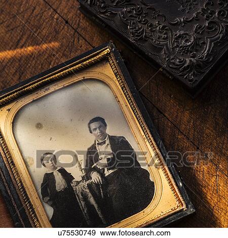 Stock Photo - Studio shot of old fashioned photograph in picture frame. Fotosearch