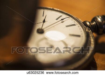 Stock Photograph - Studio shot of old fashioned pocket watch. Fotosearch