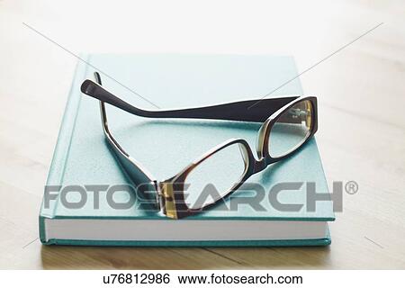 Studio shot of spectacles on book View Large Photo Image Stock Photograph - Studio shot of spectacles on book. Fotosearch