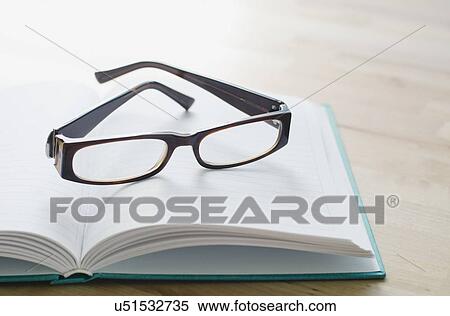 Stock Photography - Studio shot of spectacles on book. Fotosearch