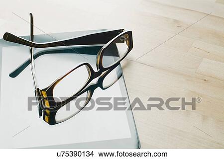 Picture - Studio shot of sunglasses on tablet. Fotosearch