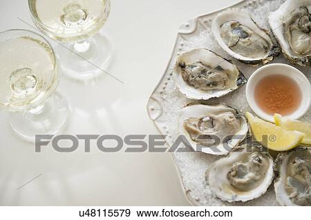 Studio shot of white wine and oysters View Large Photo Image Stock Photo - Studio shot of white wine and oysters. Fotosearch