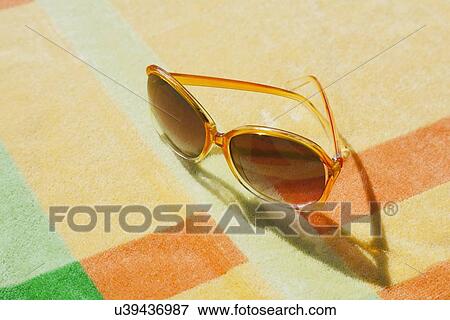 Stock Photo - Sunglasses on blanket. Fotosearch