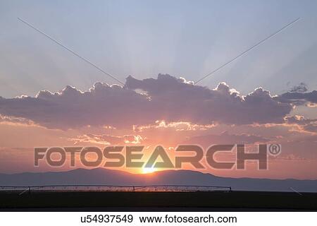 Stock Photo - Sunset over mountain range. Fotosearch