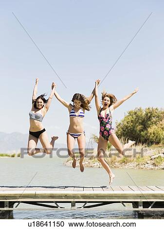 Three women jumping into lake View Large Photo Image Stock Image - Three women jumping into lake. Fotosearch