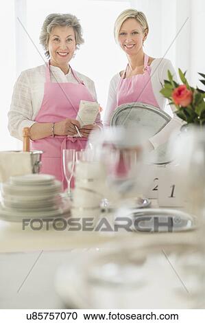 Two mature women preparing catering View Large Photo Image Stock Image - Two mature women preparing catering. Fotosearch