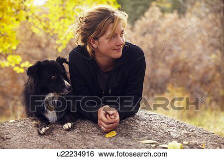 Woman and her collie leaning on rock View Large Photo Image Stock Photograph - Woman and her collie leaning on rock. Fotosearch