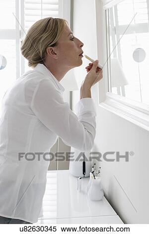 Woman applying make-up View Large Photo Image Stock Photography - Woman applying make-up. Fotosearch