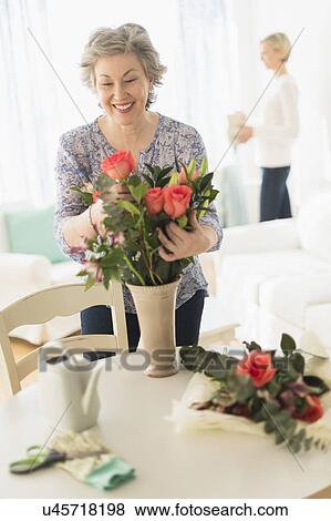 Woman arranging bouquet View Large Photo Image Stock Photo - Woman arranging bouquet. Fotosearch