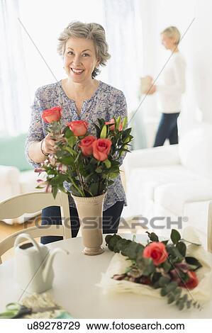 Woman arranging bouquet View Large Photo Image Stock Photo - Woman arranging bouquet. Fotosearch