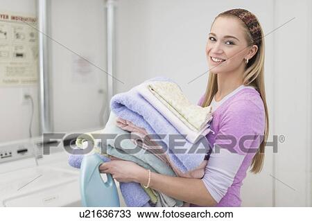 Woman carrying stack of clean towels View Large Photo Image Stock Image - Woman carrying stack of clean towels. Fotosearch
