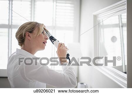 Stock Image - Woman drying hair. Fotosearch