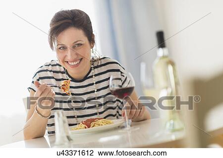 Woman eating spaghetti View Large Photo Image Stock Image - Woman eating spaghetti. Fotosearch