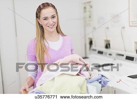Woman in laundry room View Large Photo Image Stock Image - Woman in laundry room. Fotosearch
