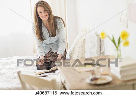 Woman kneeling on bed and writing diary View Large Photo Image Stock Photography - Woman kneeling on bed and writing diary. Fotosearch