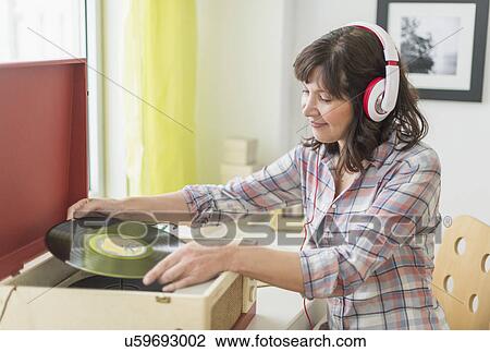 Woman listening to music on antique record player View Large Photo Image Stock Image - Woman listening to music on antique record player. Fotosearch
