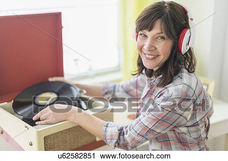 Woman listening to music on antique record player View Large Photo Image Stock Image - Woman listening to music on antique record player. Fotosearch