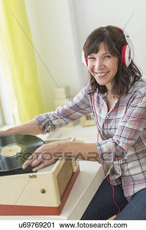Woman listening to music on antique record player View Large Photo Image Stock Image - Woman listening to music on antique record player. Fotosearch