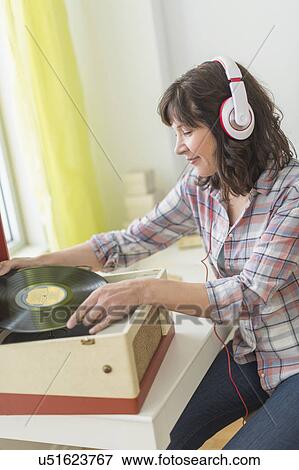 Woman listening to music on antique record player View Large Photo Image Stock Photo - Woman listening to music on antique record player. Fotosearch
