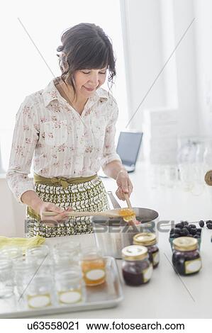 Woman making preserves in kitchen View Large Photo Image Stock Image - Woman making preserves in kitchen. Fotosearch