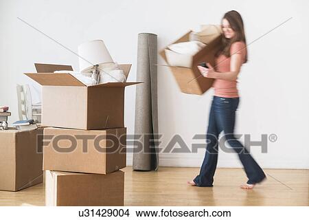 Woman moving into new home View Large Photo Image Picture - Woman moving into new home. Fotosearch