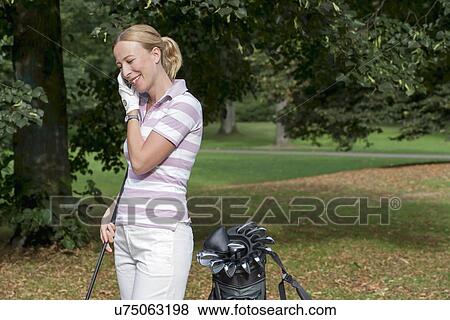 Stock Photo - Woman on golf course. Fotosearch