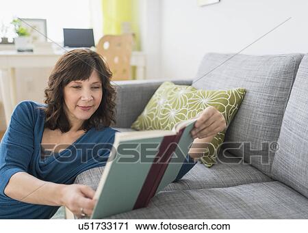 Woman reading book at home View Large Photo Image Stock Image - Woman reading book at home. Fotosearch