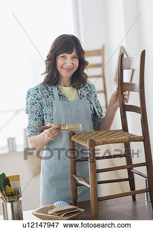 Woman restoring antique furniture View Large Photo Image Stock Photo - Woman restoring antique furniture. Fotosearch