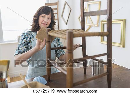 Stock Photo - Woman restoring antique furniture. Fotosearch
