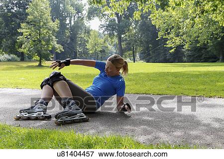 Woman roller skating in park View Large Photo Image Stock Photo - Woman roller skating in park. Fotosearch