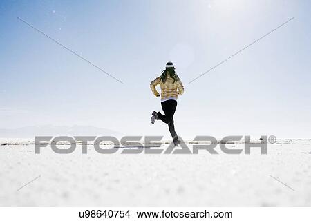 Woman running on snow View Large Photo Image Picture - Woman running on snow. Fotosearch