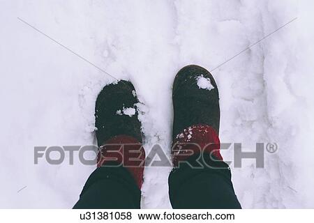 Woman standing on snow, low section View Large Photo Image Stock Photo - Woman standing on snow, low section. Fotosearch
