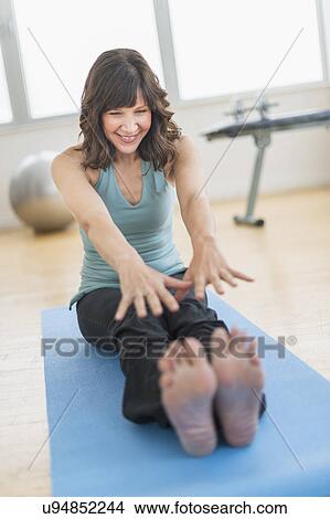 Woman stretching in gym View Large Photo Image Picture - Woman stretching in gym. Fotosearch