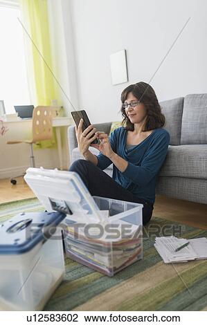 Woman using tablet pc at home View Large Photo Image Stock Image - Woman using tablet pc at home. Fotosearch