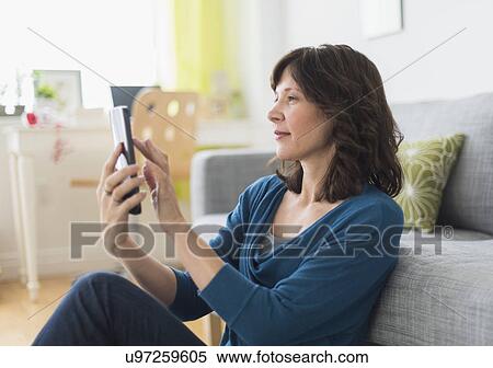 Stock Photography - Woman using tablet pc at home. Fotosearch