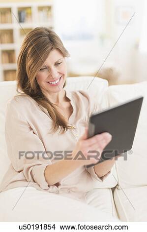 Woman using tablet pc View Large Photo Image Picture - Woman using tablet pc. Fotosearch