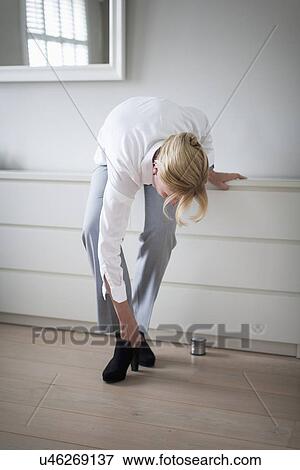 Woman zipping shoes View Large Photo Image Stock Photo - Woman zipping shoes. Fotosearch