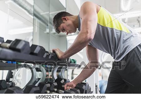 Picture - Young man at gym. Fotosearch