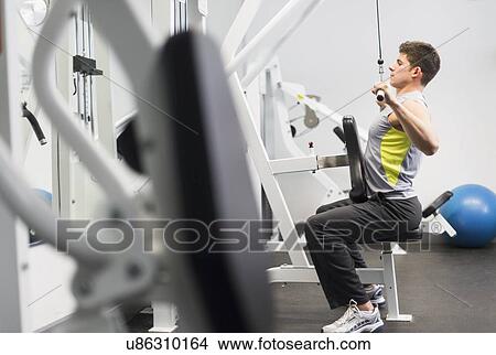 Young man at gym View Large Photo Image Picture - Young man at gym. Fotosearch